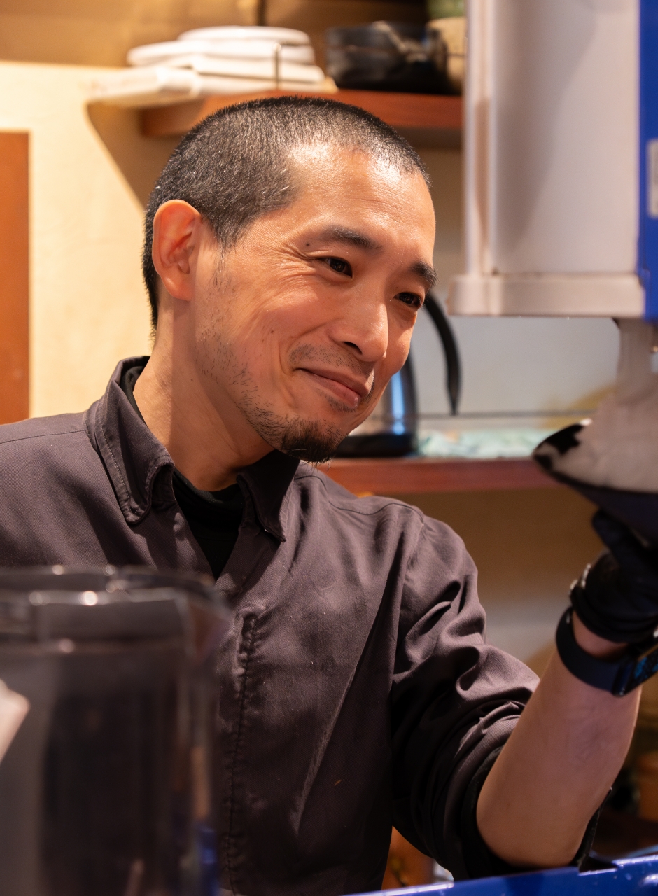 厨房で提供料理を作る男性